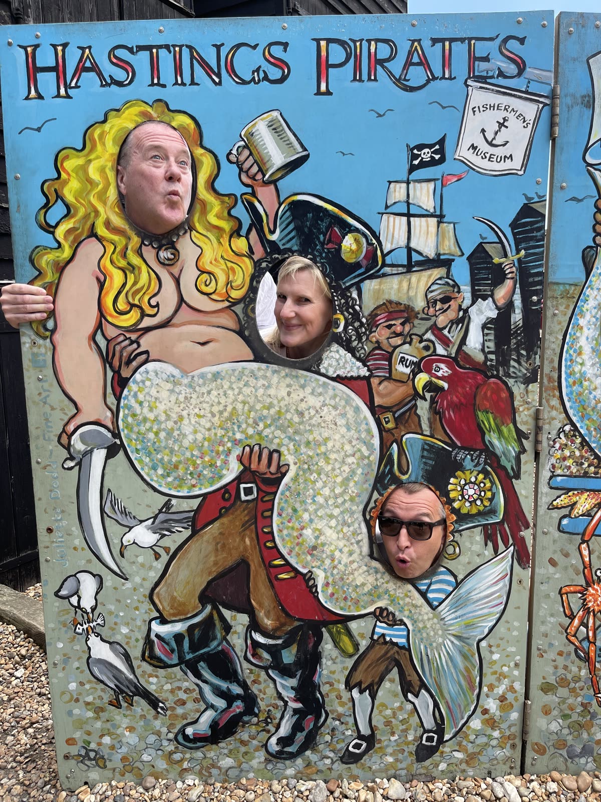 Three people smiling together in pirate-themed dress