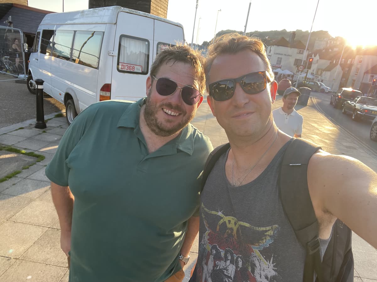 Two friends smiling in evening sun in Hastings