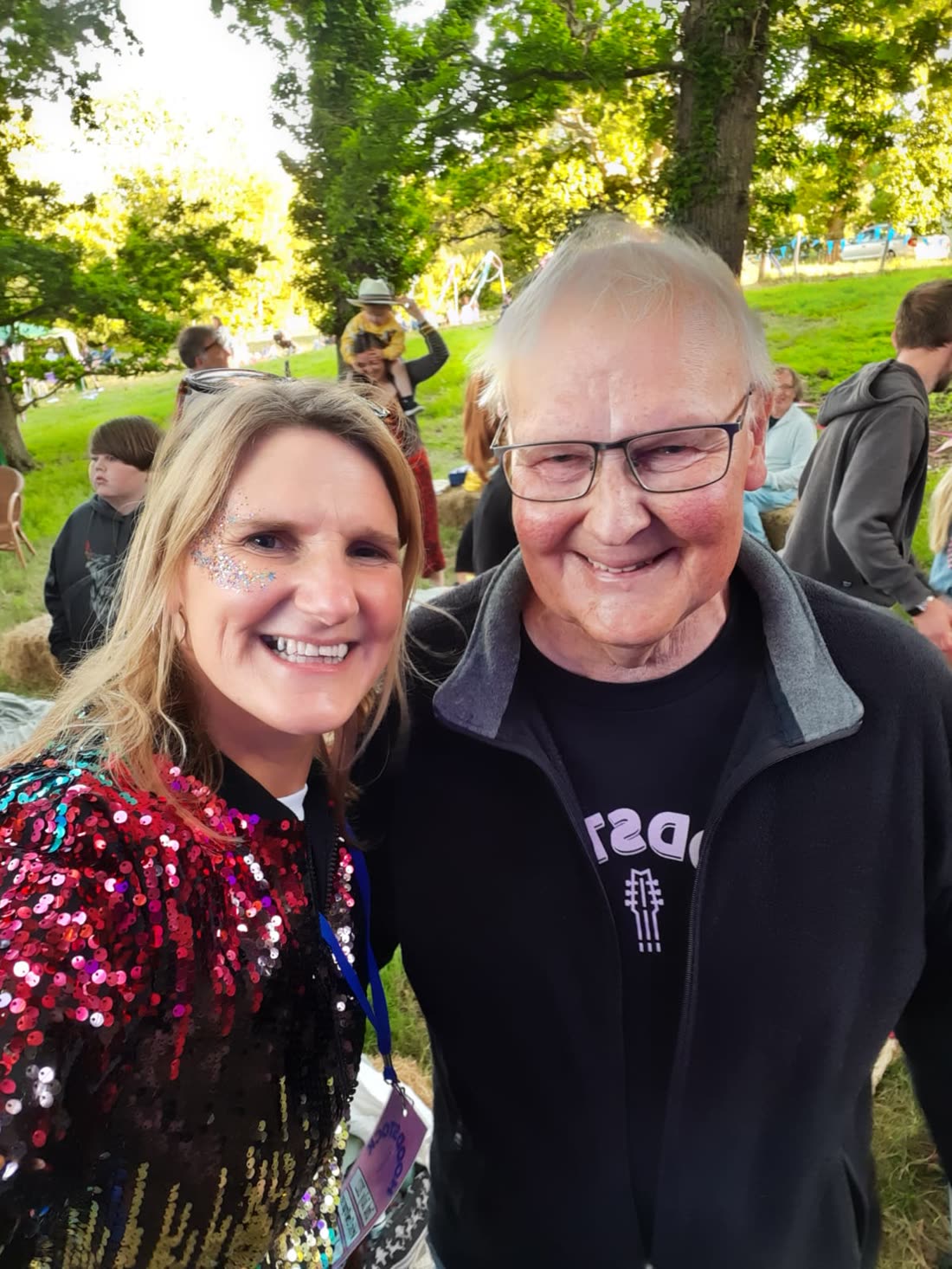 Two people smiling together among the crowd